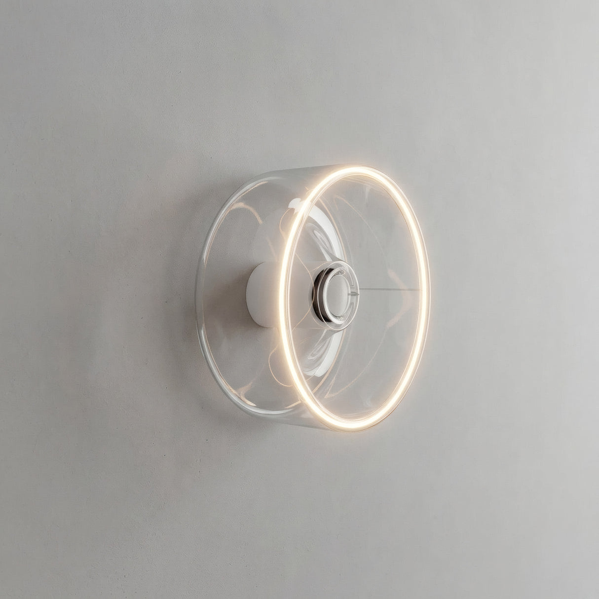 Bombilla LED donut E27 de cristal transparente, Ø 195 mm, encendida como aplique de pared en un interior sobrio