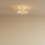 Bombilla LED donut E27 de cristal transparente, Ø 195 mm, encendida en el techo de un interior sobrio